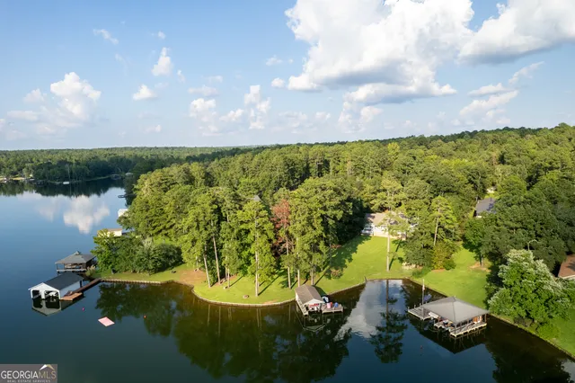 a view of a lake with a large pool and a yard