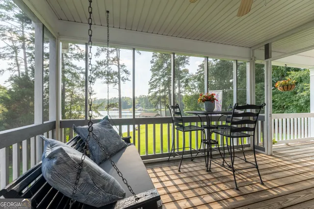 a view of a balcony with wooden floor and fence