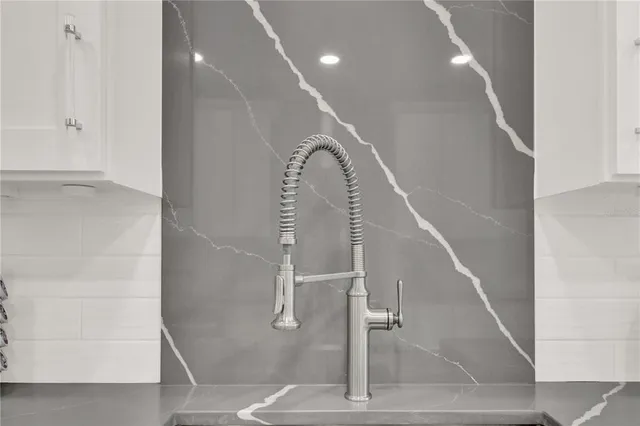 a dining room with furniture a chandelier and wooden floor