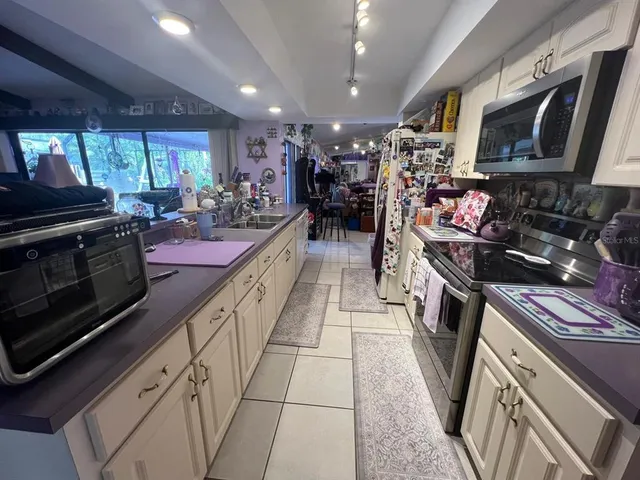 a kitchen with stainless steel appliances kitchen island granite countertop a sink and cabinets