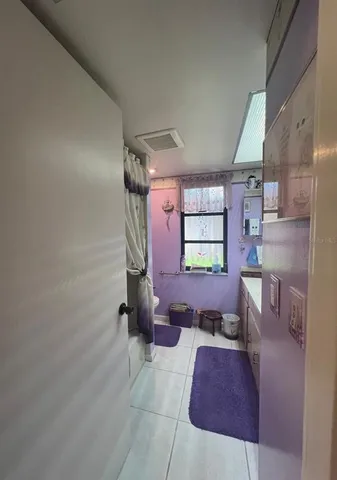 a bed sitting in a bedroom next to a large window