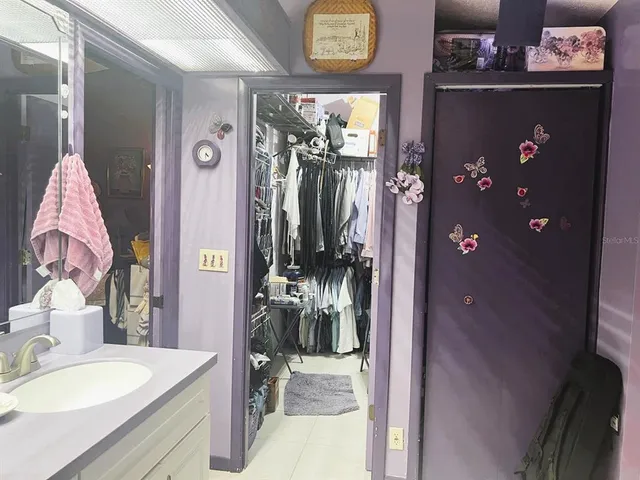 a kitchen with a refrigerator and a stove top oven