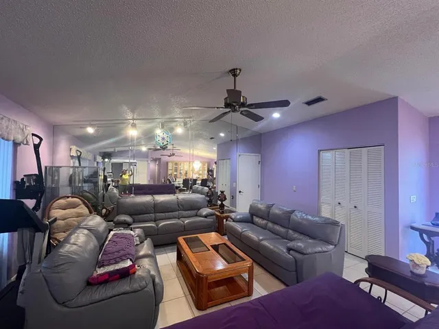 a living room with lots of furniture and a chandelier