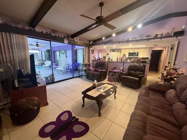 a living room filled with furniture and a large window