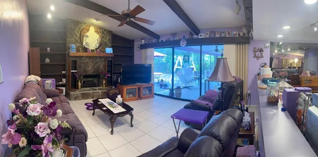 a kitchen with stainless steel appliances granite countertop a stove top oven a sink a refrigerator and white cabinets