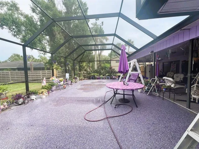 a view of a patio with a table and chairs under an umbrella