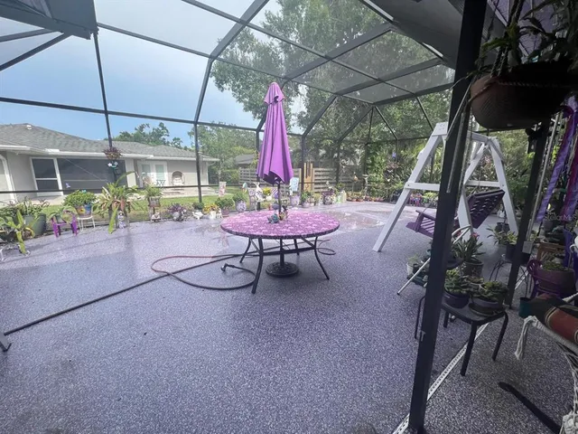 a room with lots of potted plants and a large tree