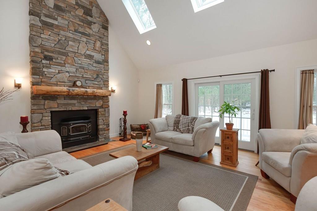 154 Brooks Station Road Princeton, MA 01541 - Photo 1 of 40 a living room with furniture and a fireplace
