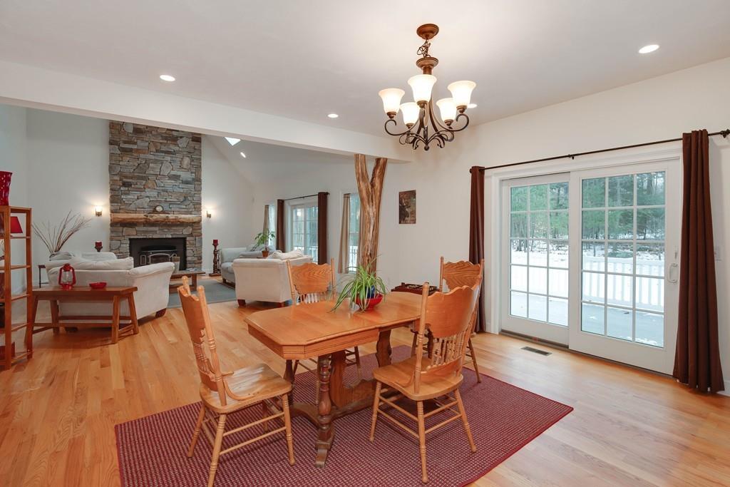 154 Brooks Station Road Princeton, MA 01541 - Photo 13 of 40 a dining room with wooden floor a chandelier a wooden table and chairs