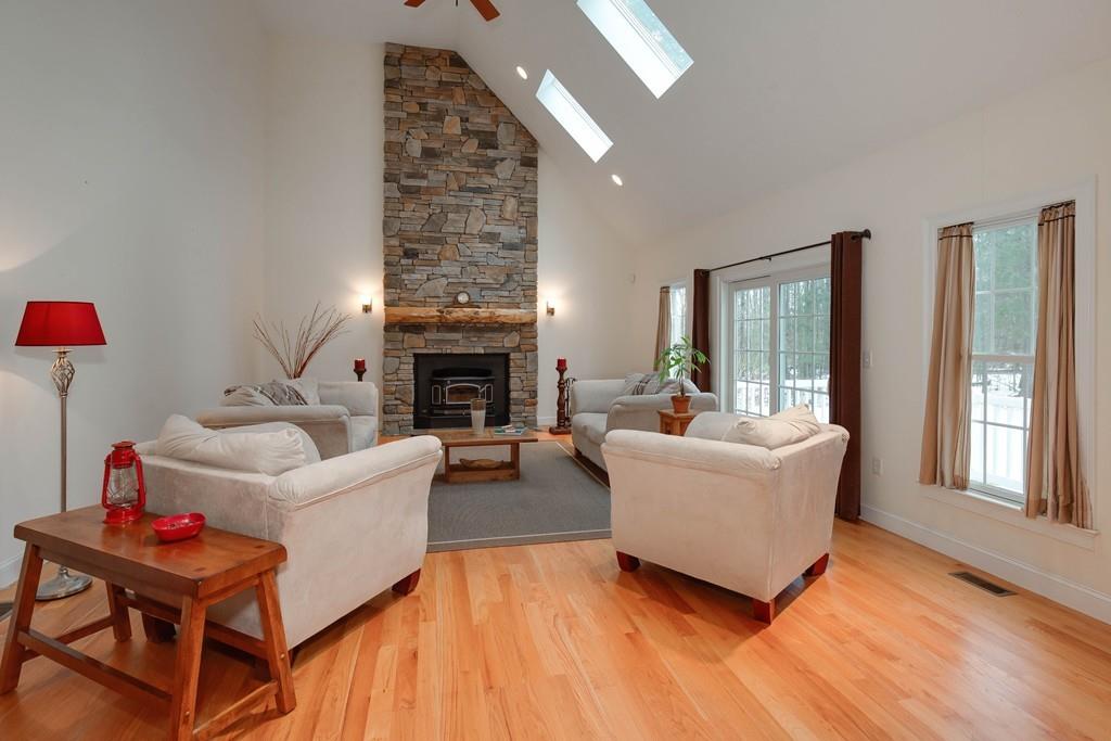 154 Brooks Station Road Princeton, MA 01541 - Photo 14 of 40 a living room with furniture and a fireplace