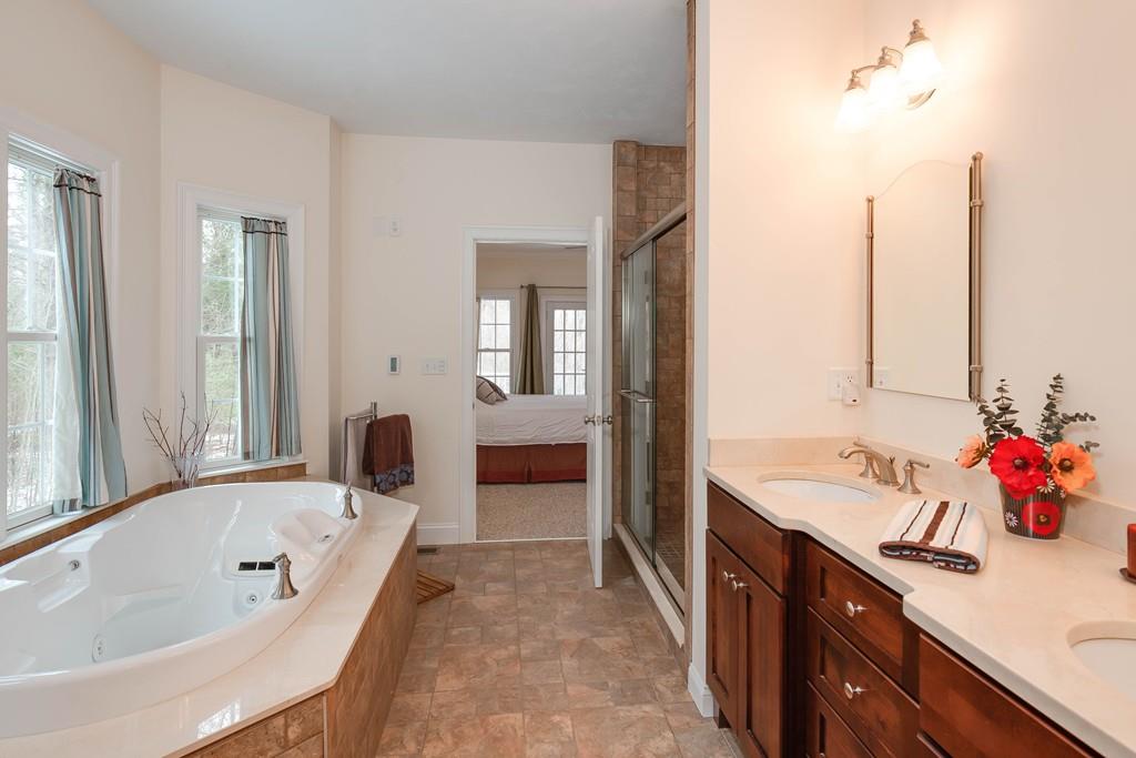 154 Brooks Station Road Princeton, MA 01541 - Photo 18 of 40 a spacious bathroom with a tub sink and mirror