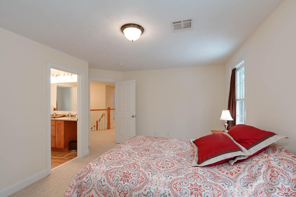 154 Brooks Station Road Princeton, MA 01541 - Photo 27 of 40 a bedroom with a bed and a lamp