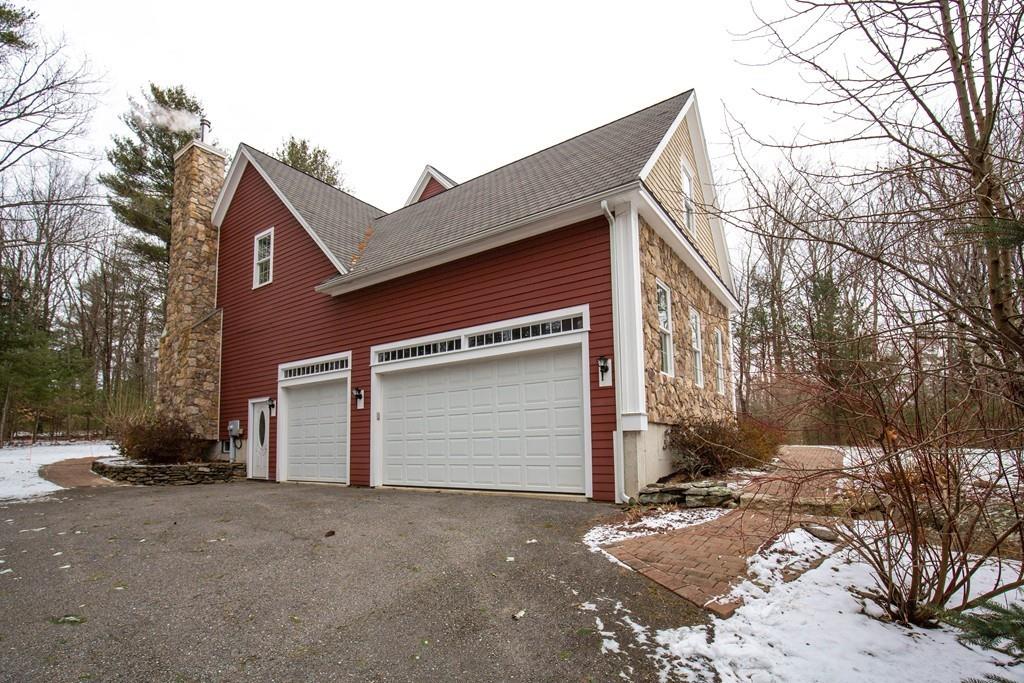 154 Brooks Station Road Princeton, MA 01541 - Photo 34 of 40 a front view of a house with a yard and garage