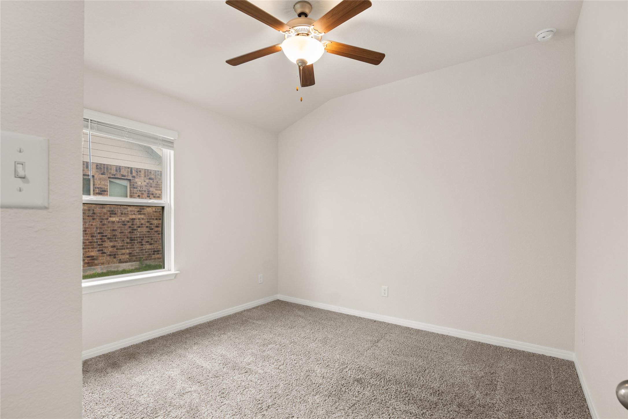 105 Saviano Road Hutto, TX 78634 - Photo 12 of 22 Secondary Bedroom #1: A well-lit bedroom offering a cozy retreat with soft carpeting and a cooling ceiling fan.