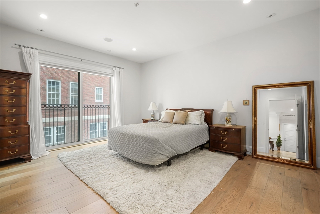 205 E Street, Unit 8N Boston, MA 02127 - Photo 12 of 29 a spacious bedroom with a large bed and a large window