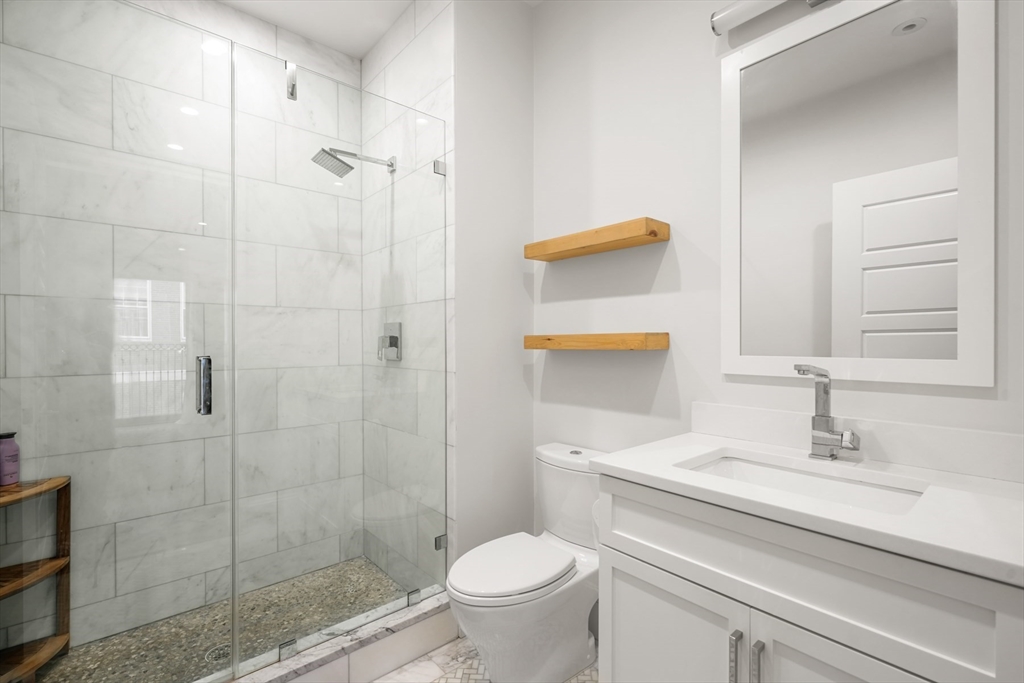 205 E Street, Unit 8N Boston, MA 02127 - Photo 15 of 29 a bathroom with a sink toilet and shower
