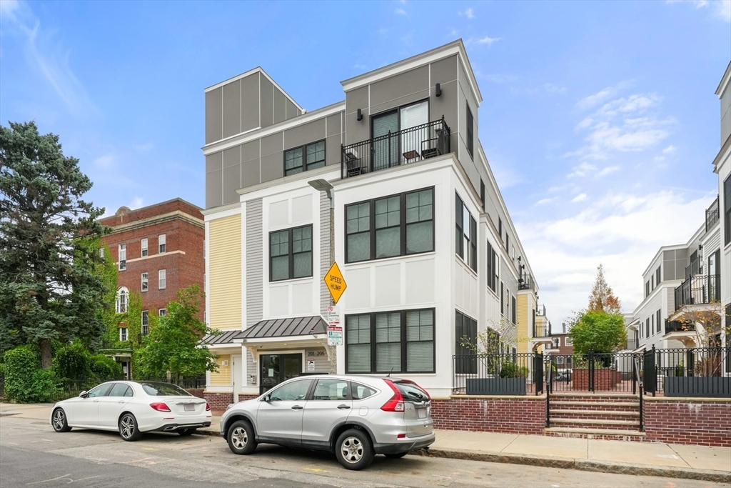 205 E Street, Unit 8N Boston, MA 02127 - Photo 27 of 29 a car parked in front of a building