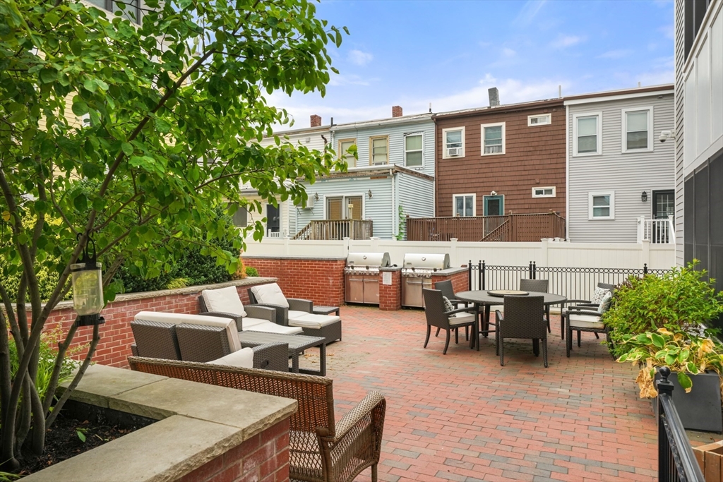 205 E Street, Unit 8N Boston, MA 02127 - Photo 29 of 29 a backyard of a house with outdoor seating