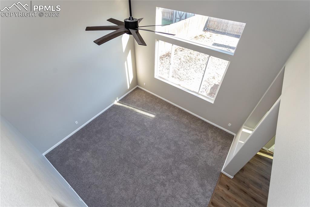 890 Rancher Drive Fountain, CO 80817 - Photo 21 of 42 The stairs overlook the 2 story living room with lovely ceiling fan.
