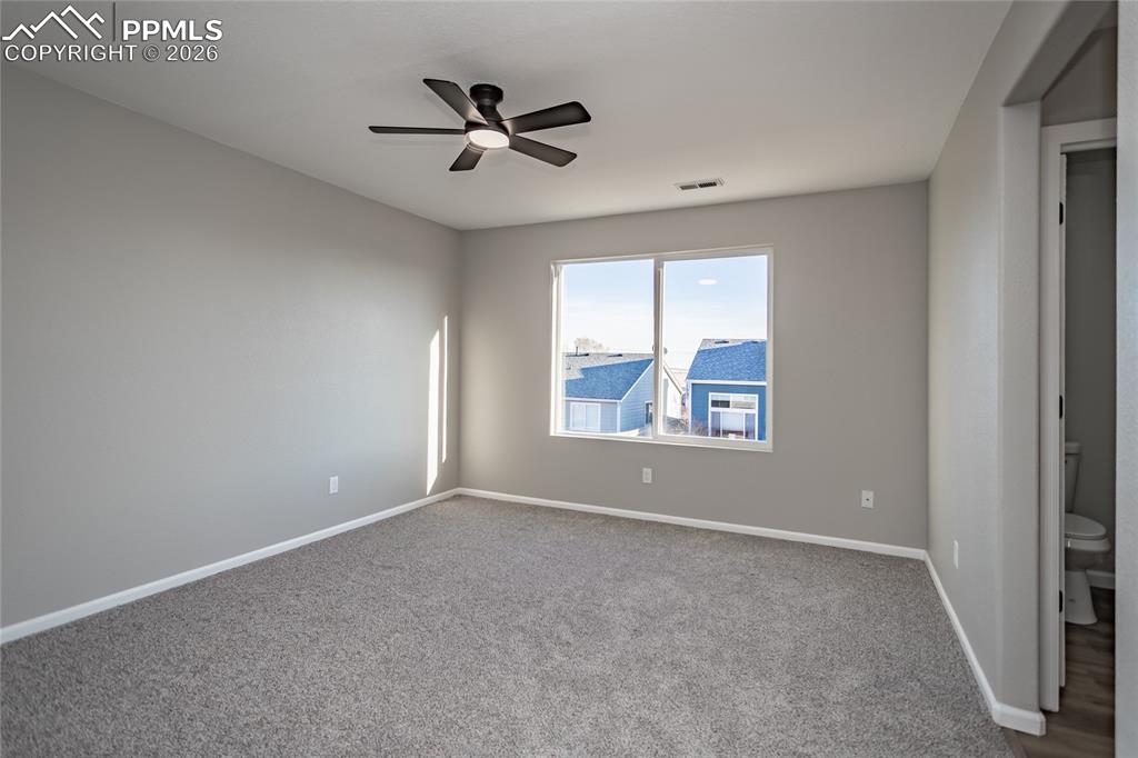 890 Rancher Drive Fountain, CO 80817 - Photo 30 of 42 The primary bedroom has an ensuite and walk-in closet, new paint, carpet, outlets, switches and ceiling fan!