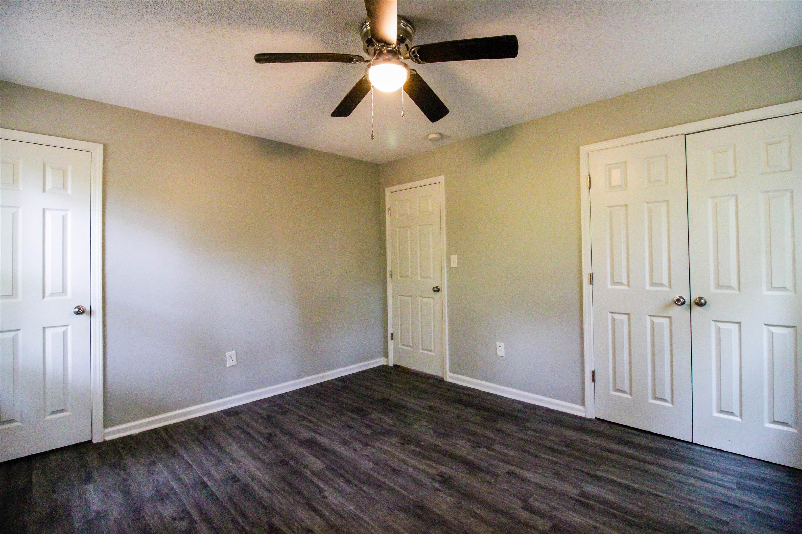 2089 Ralph Road Covington, TN 38019 - Photo 11 of 28 Bedroom featuring dark wood-style flooring, a ceiling fan, a textured ceiling, and a closet & Full Bath