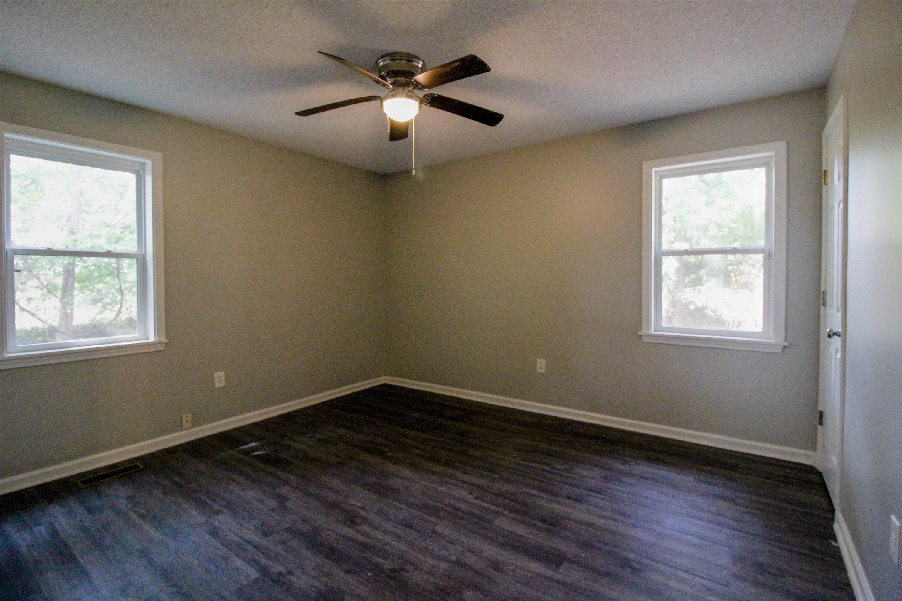 2089 Ralph Road Covington, TN 38019 - Photo 14 of 28 Bedroom with dark wood-style flooring, a closet, ceiling fan, and a textured ceiling