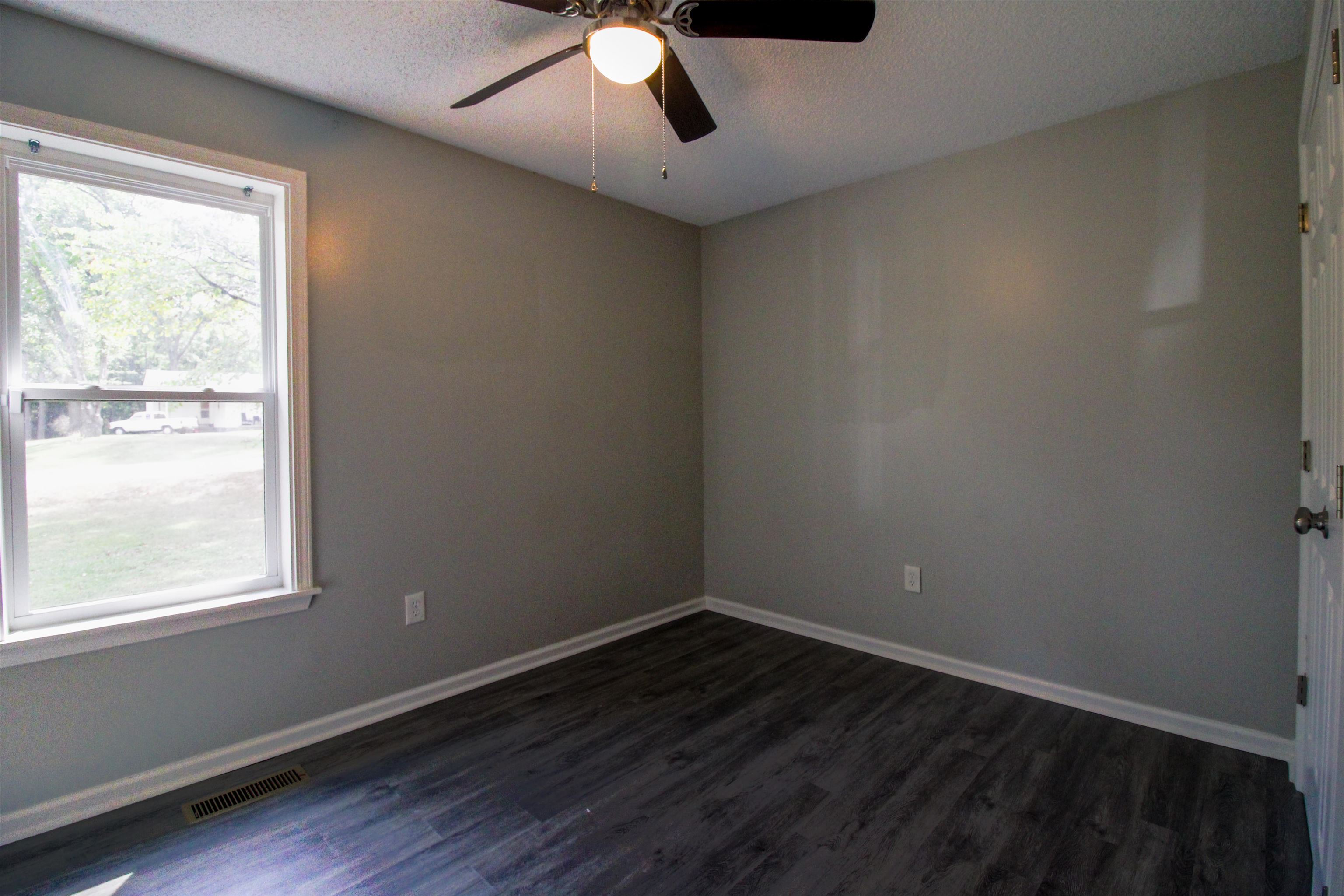 2089 Ralph Road Covington, TN 38019 - Photo 17 of 28 Bedroom featuring dark wood finished floors, a textured ceiling, and ceiling fan