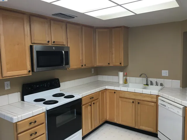 a kitchen with a sink stove and microwave