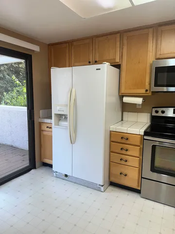 a white refrigerator freezer sitting in a kitchen