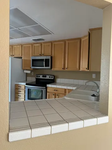 a kitchen with stainless steel appliances granite countertop a sink and a stove