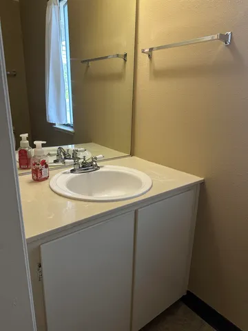 a bathroom with a sink and a mirror