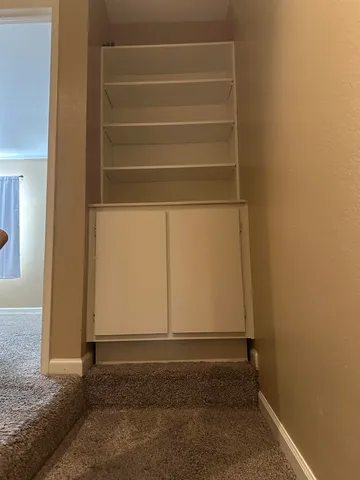 an empty room with a window and a ceiling fan