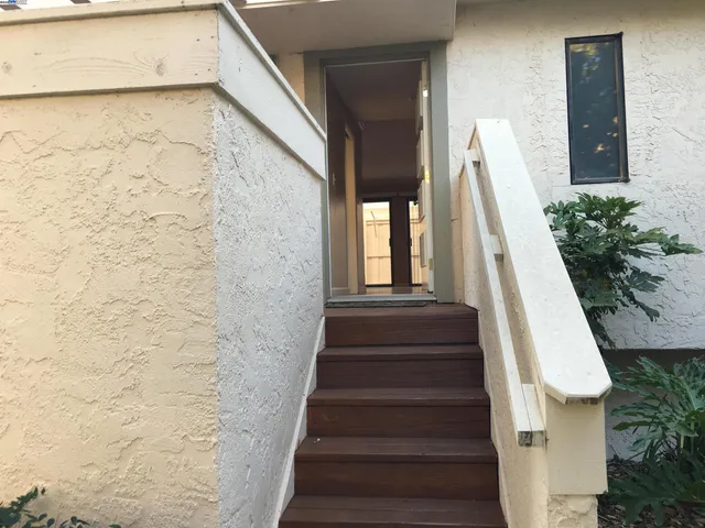 a view of staircase with white walls and stairs