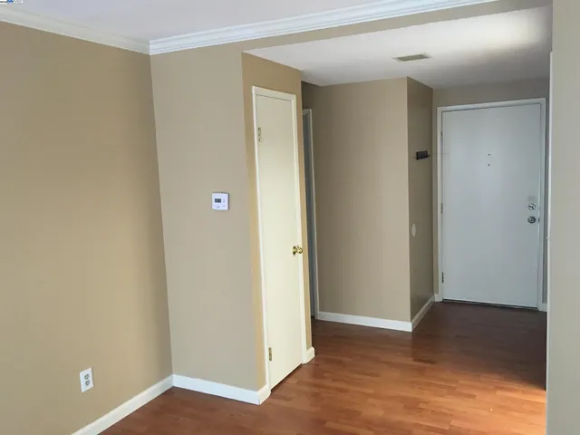 a view of an empty room and wooden floor