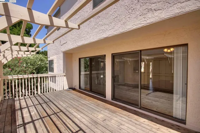 a view of a balcony with wooden floor