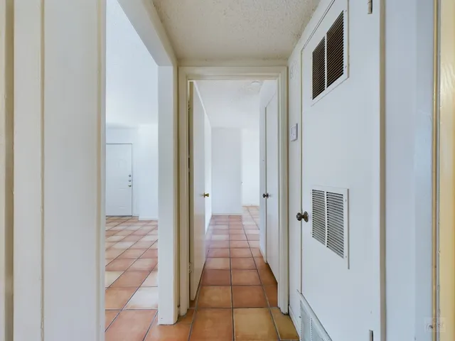 a view of a hallway with wooden floor and entryway