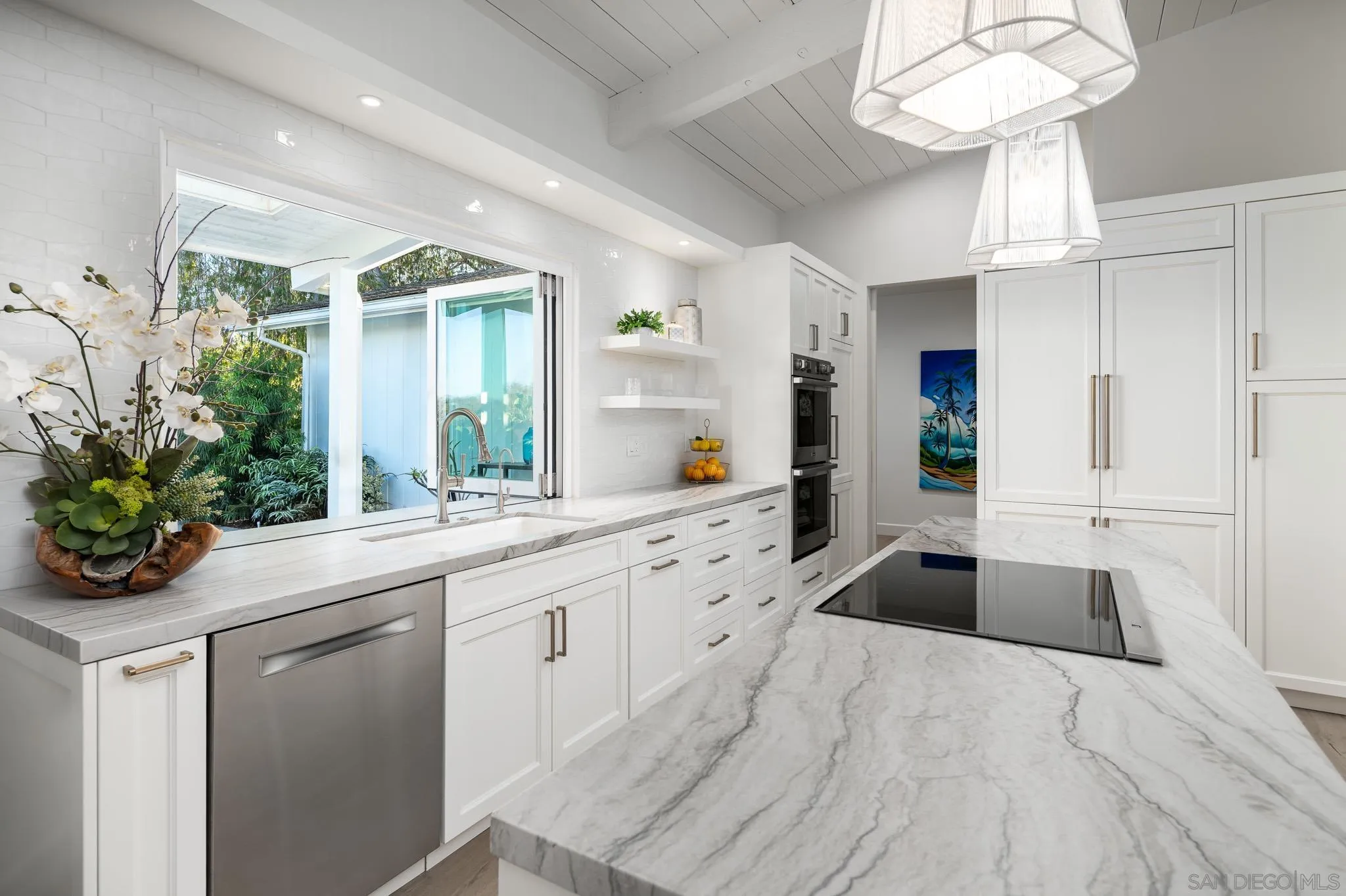 16039 Via Del Alba Rancho Santa Fe, CA 92067 - Photo 14 of 56 a large white kitchen with a sink and cabinets