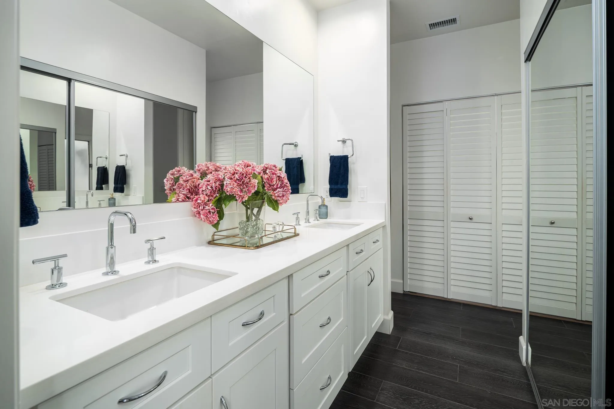 16039 Via Del Alba Rancho Santa Fe, CA 92067 - Photo 32 of 56 a bathroom with a double vanity sink and mirror