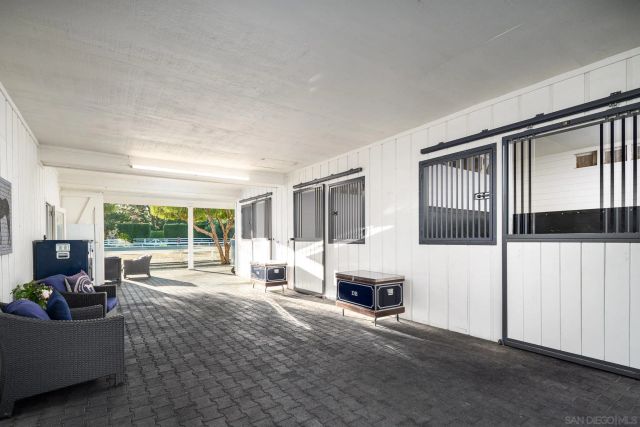 a view of a tennis ground with large trees