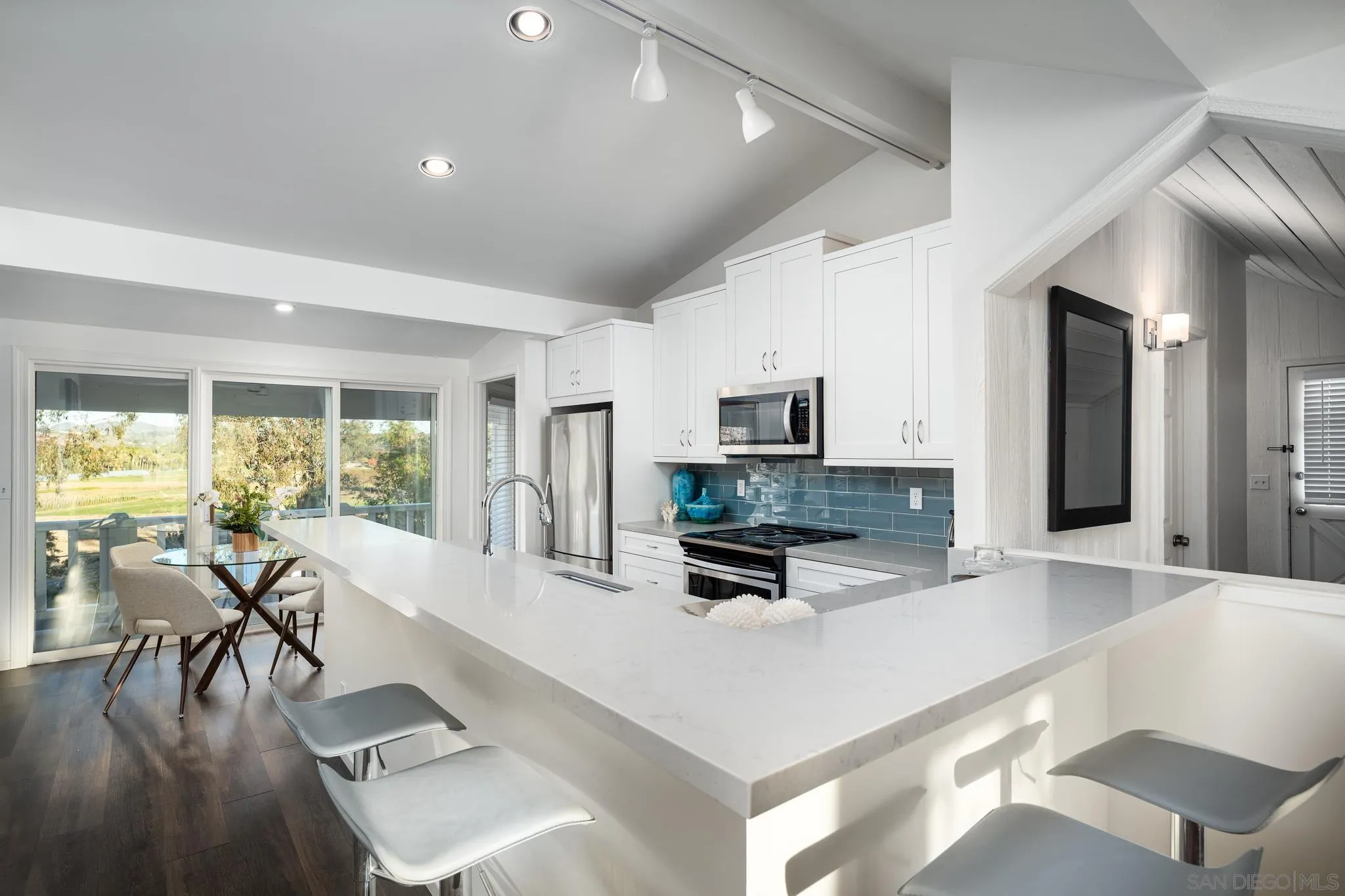 16039 Via Del Alba Rancho Santa Fe, CA 92067 - Photo 49 of 56 a large white kitchen with a large window appliances and furniture