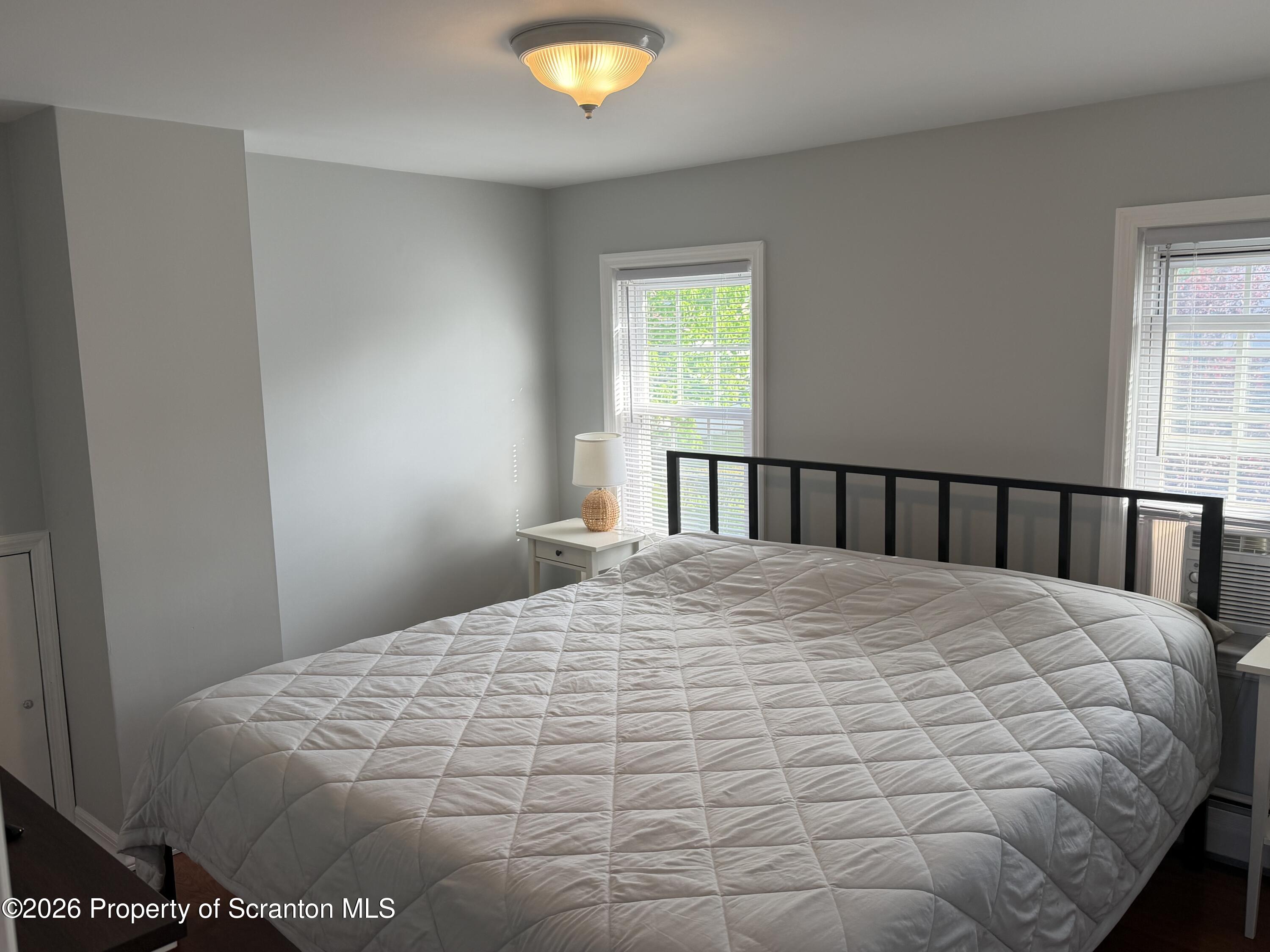 320 Haverly Street Throop, PA 18512 - Photo 15 of 27 a large bed sitting in a bedroom next to a window