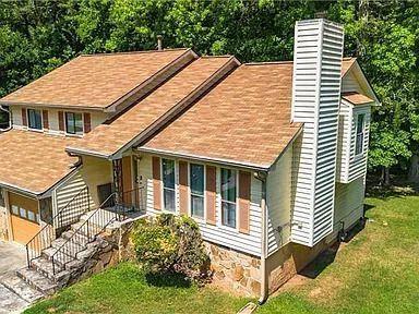 a aerial view of a house with a yard and potted plants
