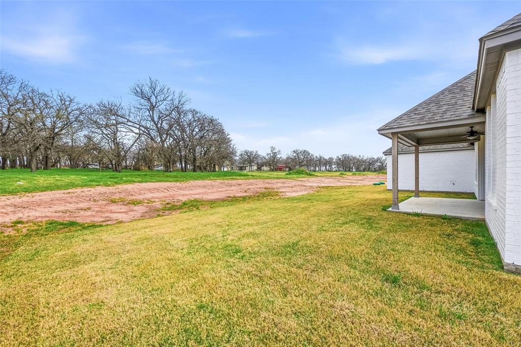 1005 Ronnie Court Springtown, TX 76082 - Photo 26 of 27 View of grassy yard with a patio area and ceiling fan