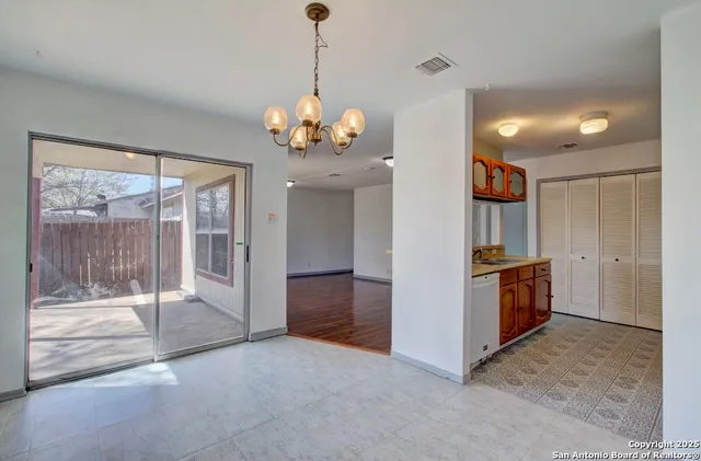 a view of a kitchen with a sink and refrigerator