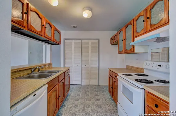a kitchen that has a sink and a stove