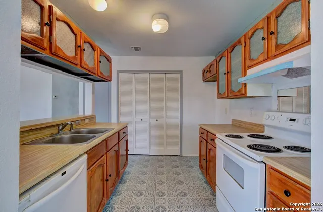 a kitchen that has a sink and a stove