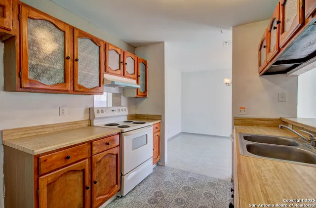 a kitchen with stainless steel appliances granite countertop a stove and a sink