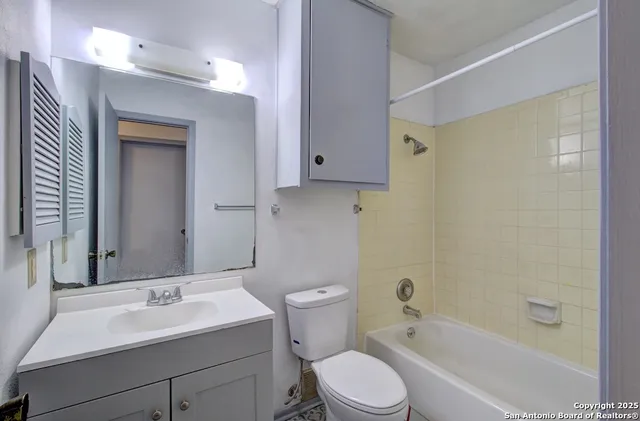 a bathroom with a sink toilet vanity and shower