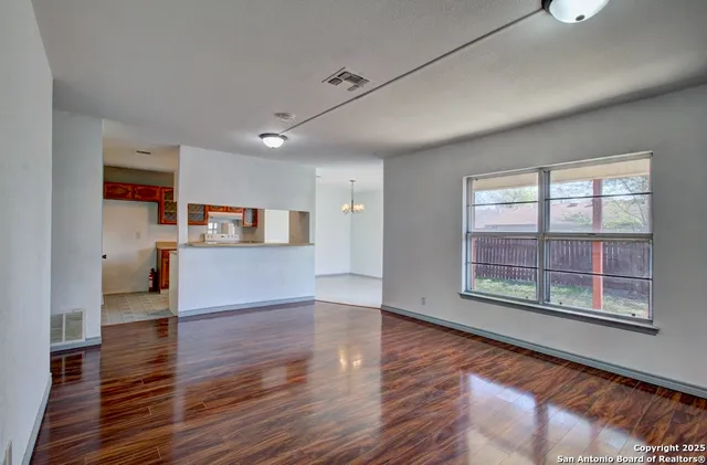 a view of a kitchen with wooden floor and a kitchen