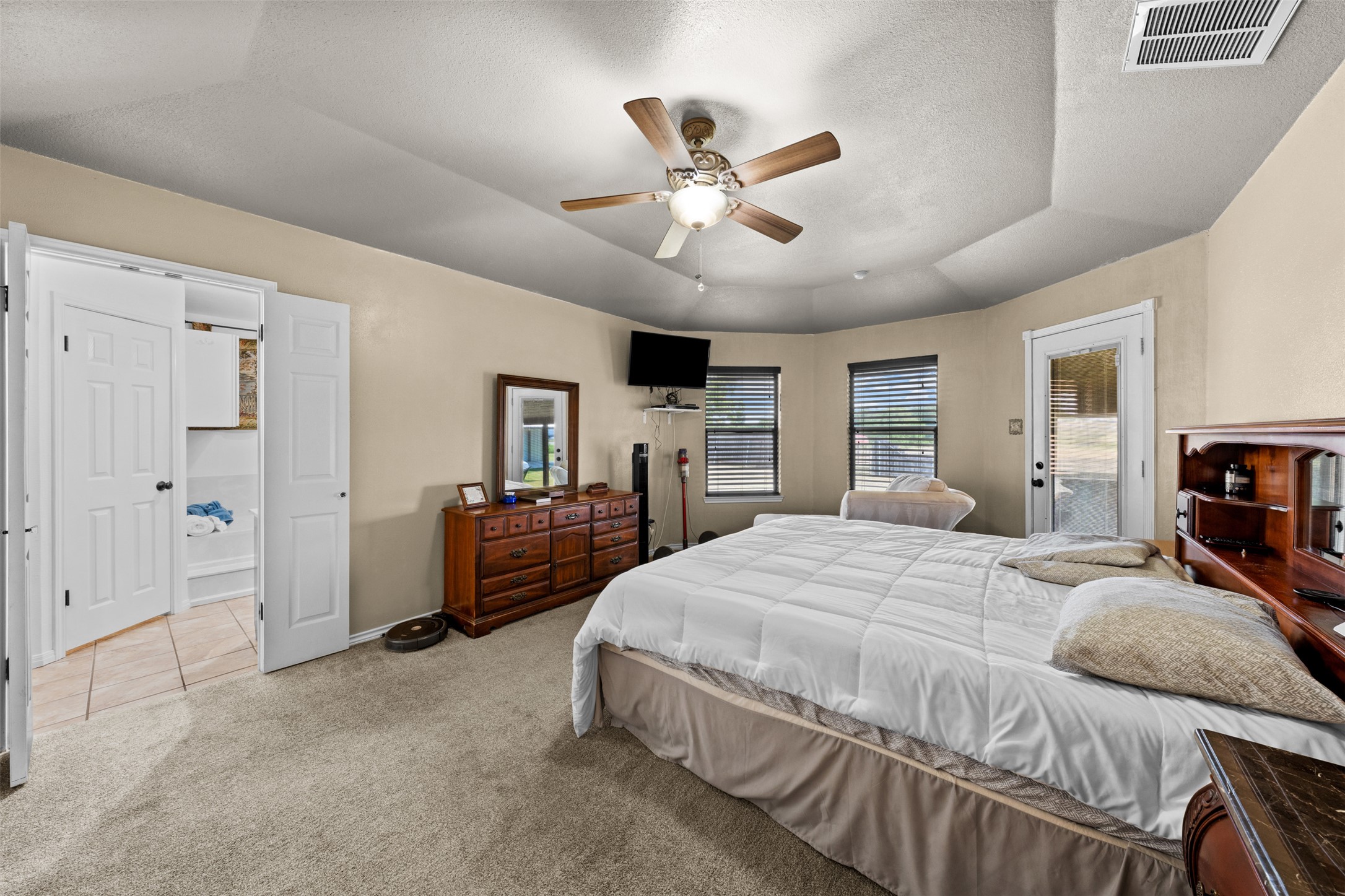 1512 Panther Loop Pflugerville, TX 78660 - Photo 14 of 40 A tray ceiling and abundant natural light create a spacious, inviting sleeping sanctuary.